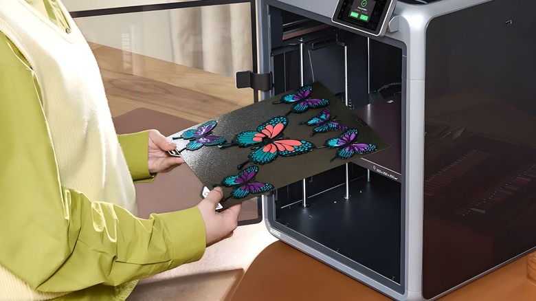 Creality K2 Combo being used to print multicolor butterflies on a wood table