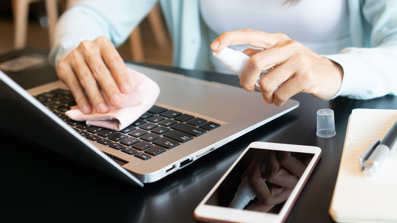 Using a rag to clean laptop keyboard