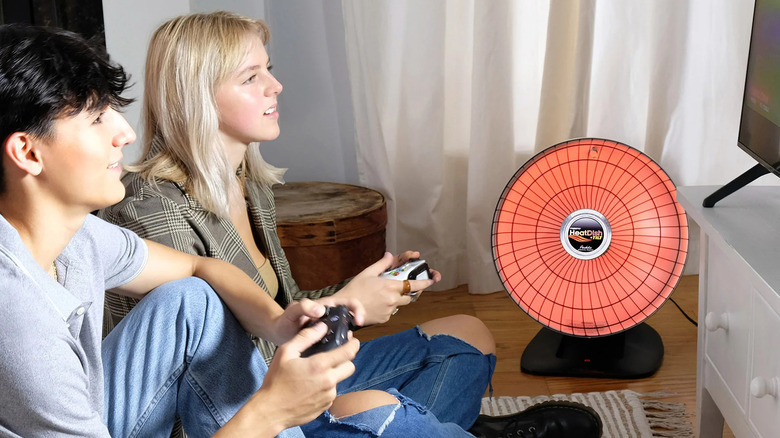A Presto HeatDish next to people playing games on a TV