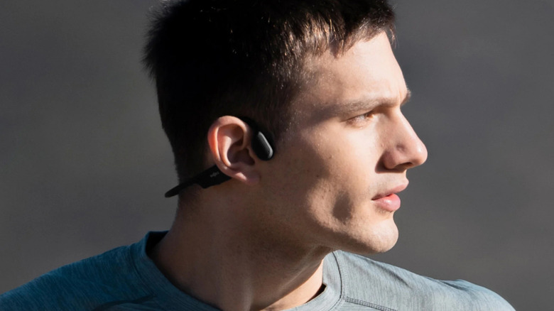 A man wearing SHOKZ headphones
