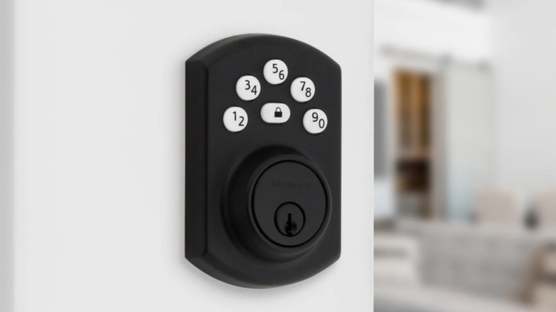 The Kwikset Powerbolt 240 Keypad Electronic Deadbolt Door Lock installed on a door.