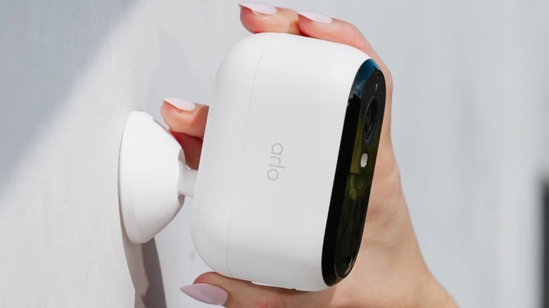 A person adjusting the Arlo Essential Camera 2K (3rd Gen).