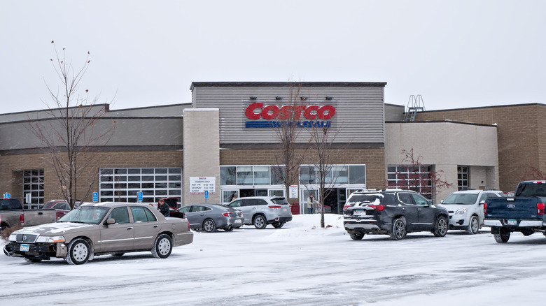 A Costco store with snow in the parking lot