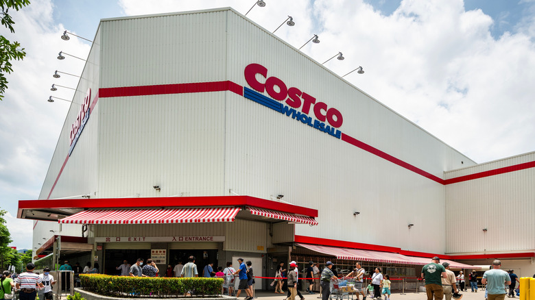 Costco storefront with multiple walking through the front entrance