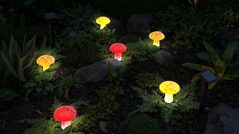Sets of Infinity X1 Glass Solar Mushroom Landscape Lights planted in the ground.