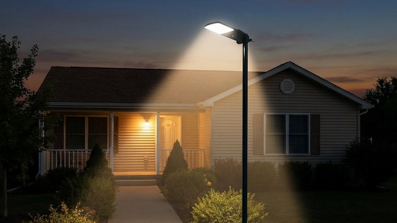 A Sol-R-Brite Fresh Source Solar Area Light in front of a house.