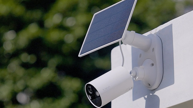 A TP-Link Tapo 2k Smart Wire-Free Security Camera and solar panel attached to a wall.