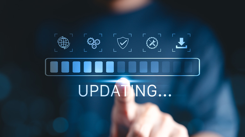 A man pointing to a loading bar in the air with an "updating" label underneath