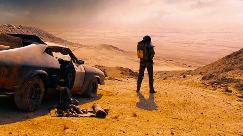 Mad Max standing by his car in Mad Max: Fury Road