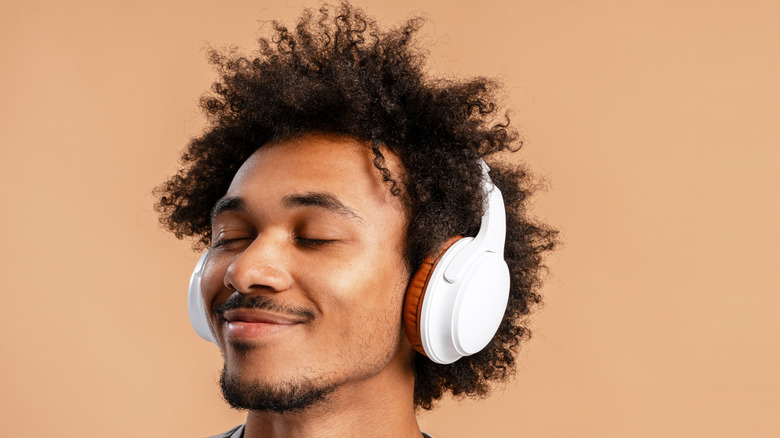 Person listening to music over headphones