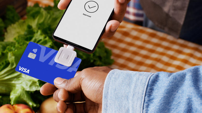 Swiping Visa card in Square Reader connected to phone