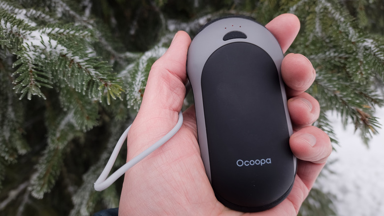 person holding a Ocoopa hand warmer