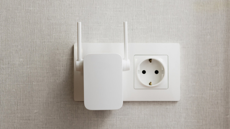 A Wi-Fi range extender connected to an electrical outlet.