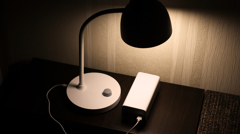 USB lamp on a nightstand being powered by a power bank