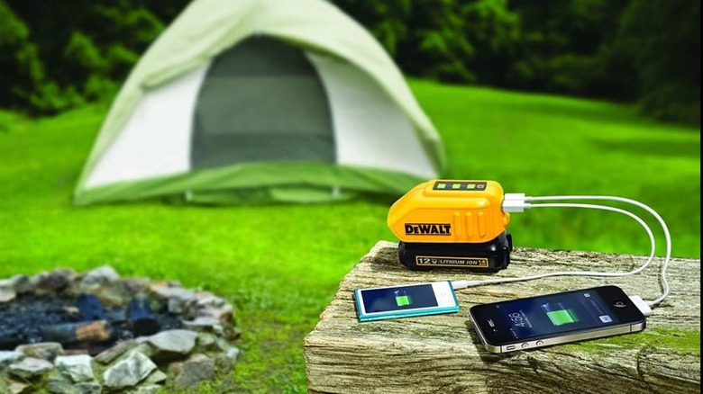 Charging devices at a campsite with the DeWalt USB charger.