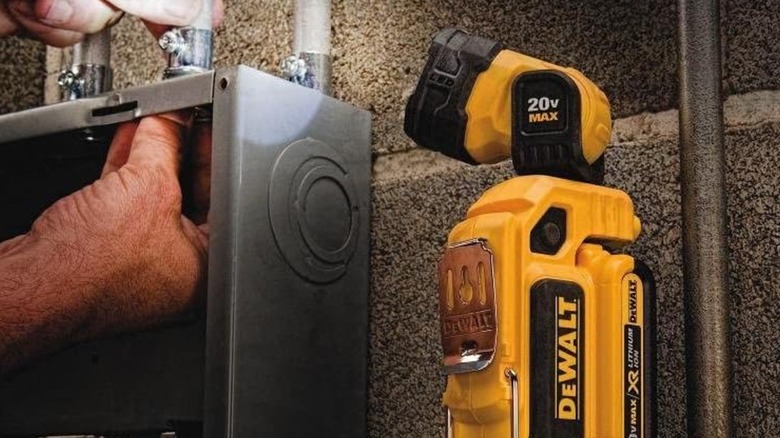 The DeWalt work light illuminating a breaker box.