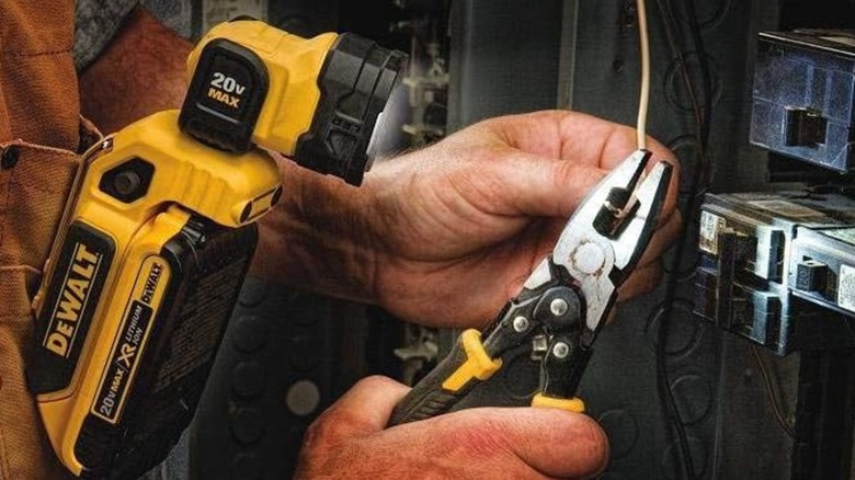 An electrician working with the DeWalt work light.