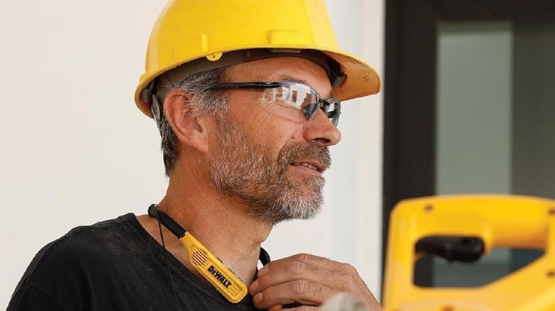 A construction worker wearing the DeWalt neckband headphones.