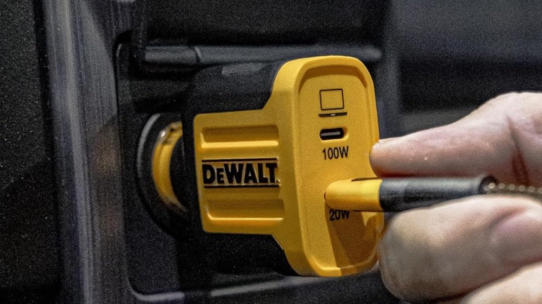 Plugging a charging cord into the DeWalt car charger.