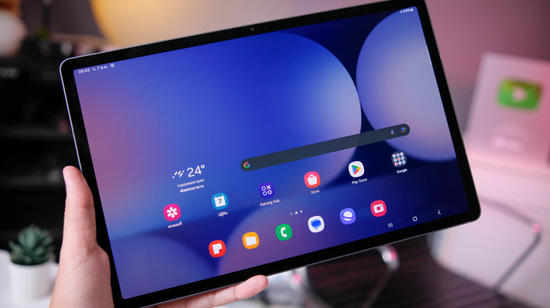 Samsung Galaxy Tab S10 held in landscape mode with the Android home screen open.
