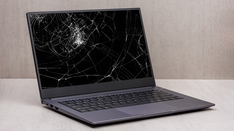 Laptop with a cracked screen placed on a table