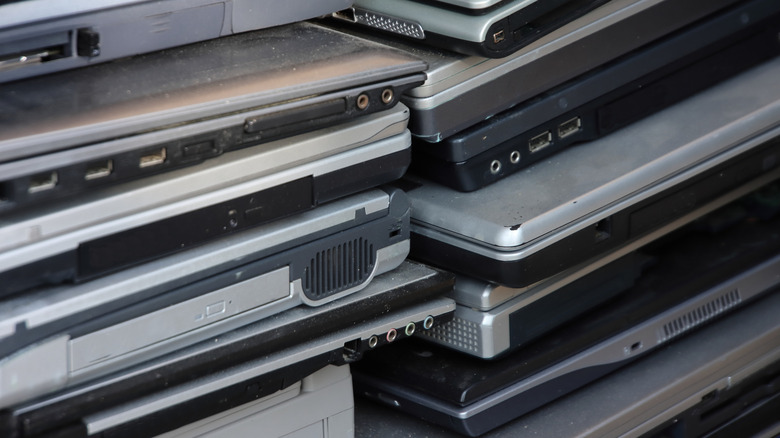 Stack of old, outdated laptops collected for recycling