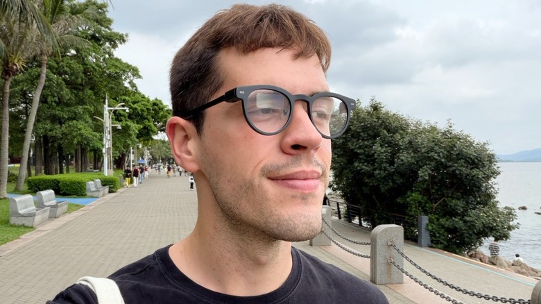 A man wearing smart glasses outdoors