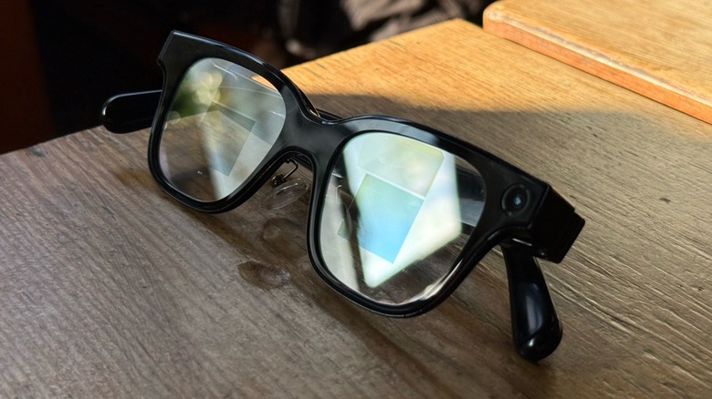 A close-up shot of smart glasses on a wooden surface