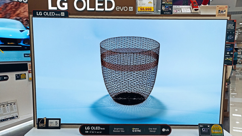 An LG OLED evo TV store display, with the set showing a basket on its screen.