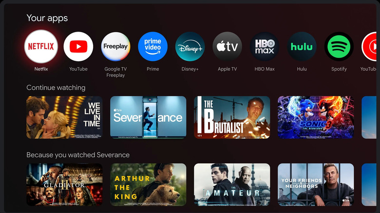 Google TV home screen showing streaming app icons, continue watching titles, and personalized recommendations.