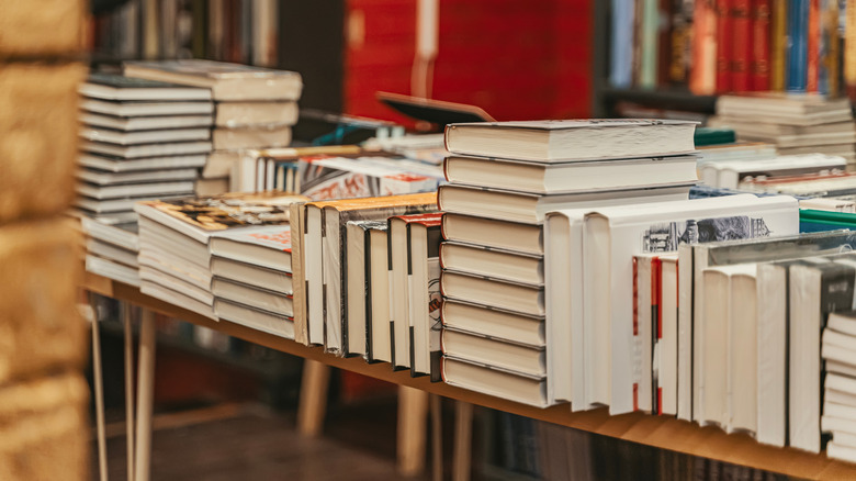 Stacks of hardcover books on a table