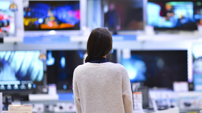 Person looking at TVs on display
