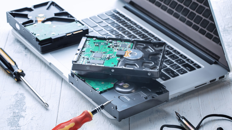 Laptop computer and hard drive undergoing repairs