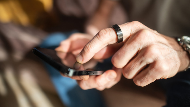 Senior man with smart ring and smart phone