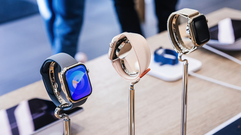 A trio of watches from the Watch 9 and Ultra 2 lineup are actively charging on display