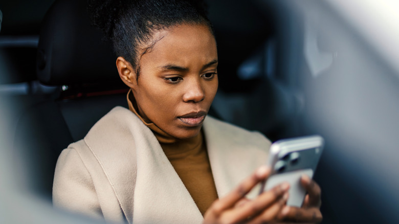 Woman looking at her smartphone with concern