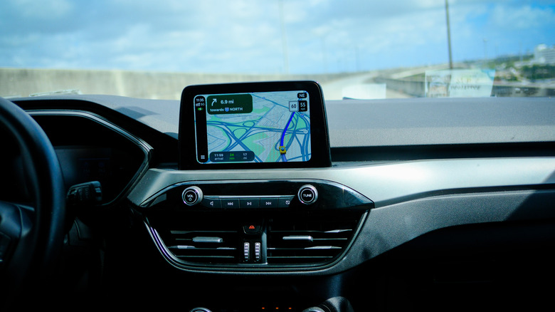 Person using a map app in a car