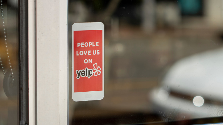 Sticker promoting Yelp on a retailer's door