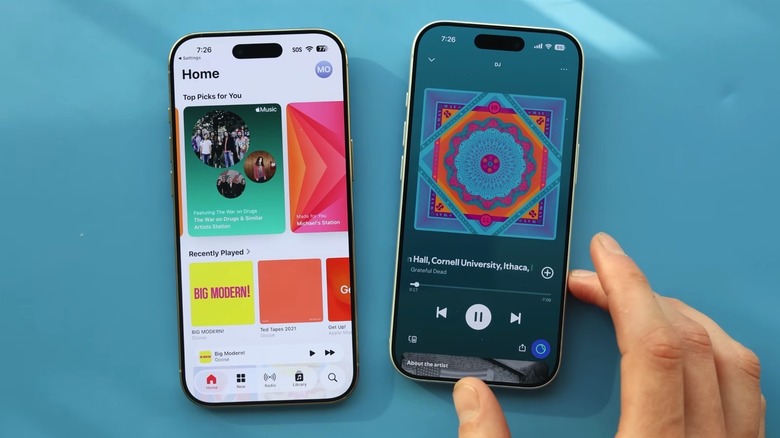 The Apple Music (left) vs. Spotify (right) apps loaded on two iPhones.