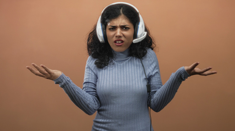 Person looking confused wearing a white headphone