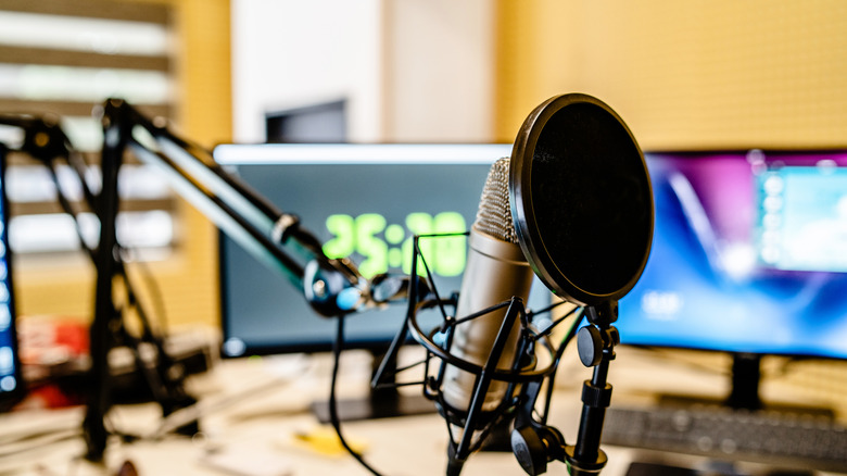 a microphone with two monitor screens behind it