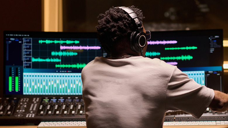 Person editing different audio streams on a monitor