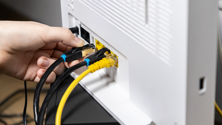 person plugging in router