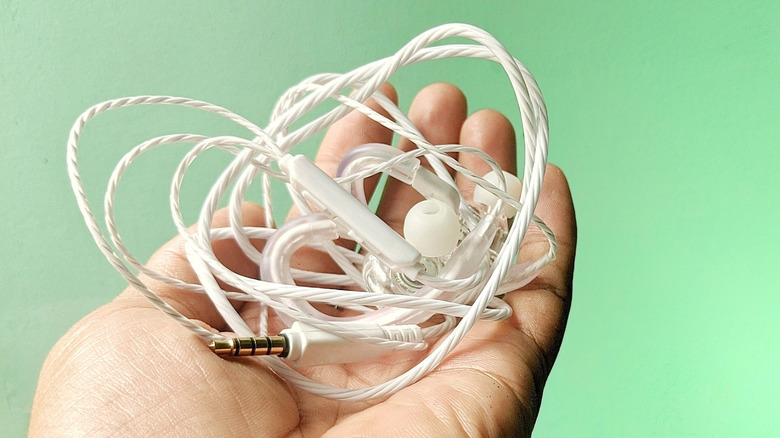 A pair of earbuds with tangled wires