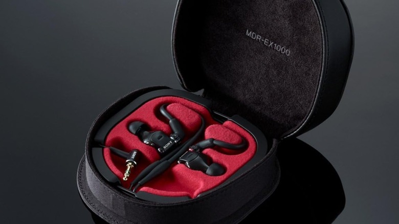 Photo of the Sony MDR-EX1000 in a case over a dark grey bacgkround