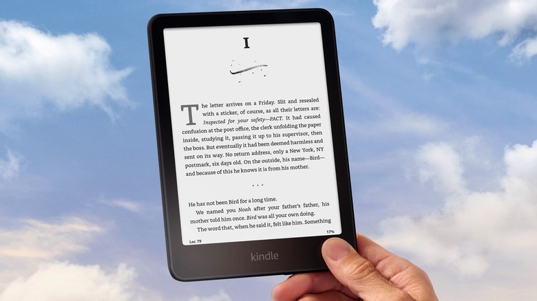 The Amazon Kindle Paperwhite in hand.