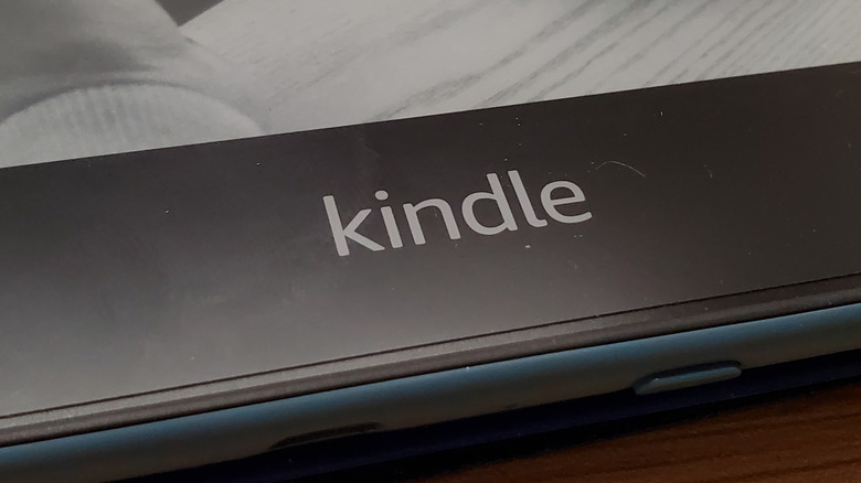 A close-up of the Kindle brand on an older Kindle Paperwhite model