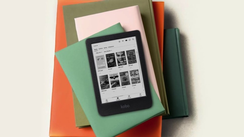 The Kobo Clara BW on top of a pile of books.