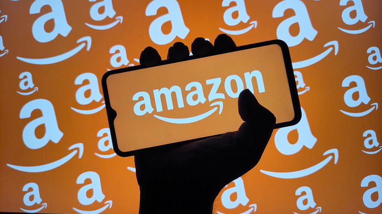hand holding a smartphone with the amazon logo on it
