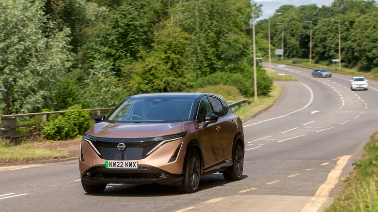 Nissan Ariya EV compact SUV driving on the road.